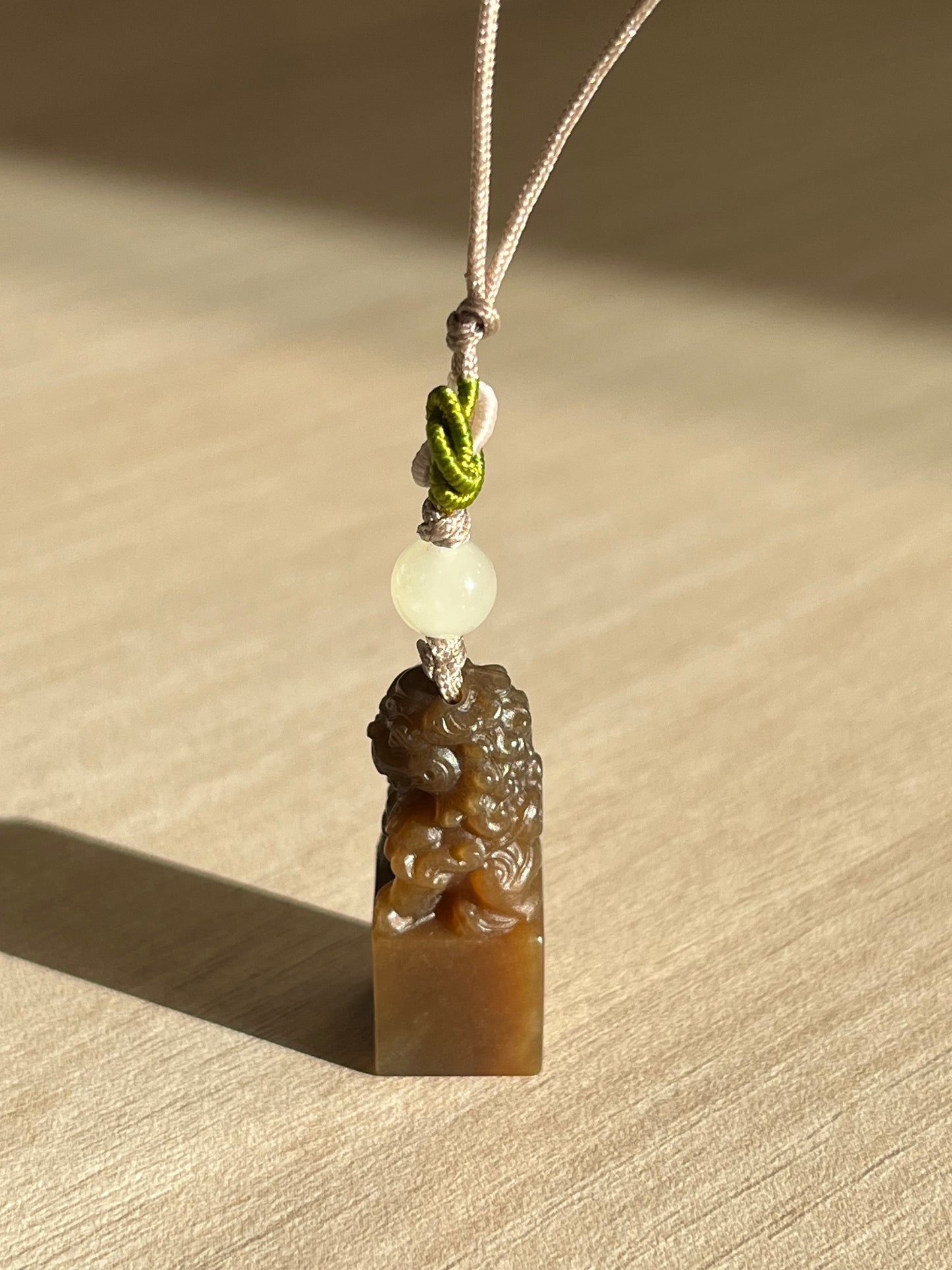 Handmade Phone Charm with a Hand Carved Brown Hetian Jade Lion，手雕和田糖玉狮子吊坠