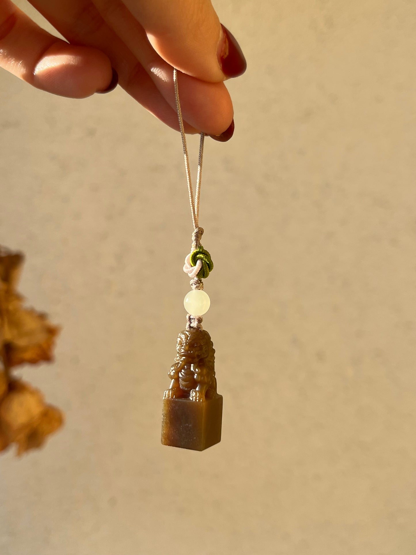 Handmade Phone Charm with a Hand Carved Brown Hetian Jade Lion，手雕和田糖玉狮子吊坠